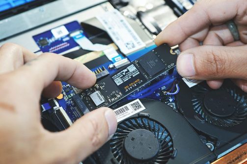 Computer Technician Fixing a Laptop